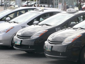 Duffy's and Unicity cabs wait for fares at the Polo Park Shopping Centre in Winnipeg, Man. Thursday Sept. 24, 2015. Duffy's and Unicity have formed the Winnipeg Taxi Alliance.