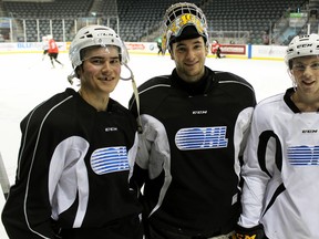 Kingston Frontenacs, from left, defencemen Chad Duchesne, goalie Lucas Peressini and right-winger Spencer Watson pose Thursday at the Rogers K-Rock Centre after their final practice before Friday’s season-opening game at home. (Steph Crosier/The Whig-Standard)