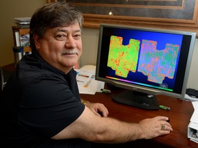 Greg Patterson, president of A & L Canada, shows two images of a farmer's field taken by a drone. The image on the left is shot with conventional technology, while the image on the right shows the enhanced detail provided by the new drone being developing.  MORRIS LAMONT / THE LONDON FREE PRESS / POSTMEDIA NETWORK