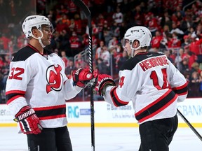Mark Fraser (left) and Adam Henrique of the New Jersey Devils celebrate the win over the Philadelphia Flyers on March 8, 2015 at the Prudential Center in Newark, N.J. (Elsa/Getty Images/AFP)