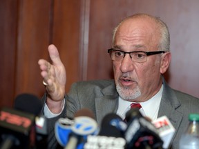Thomas J. Eoannou, a lawyer for a woman alleging she was sexually assaulted by Chicago Blackhawks forward Patrick Kane, gestures during a news conference, Wednesday, Sept. 23, 2015, in Buffalo, N.Y. (AP Photo/Gary Wiepert)
