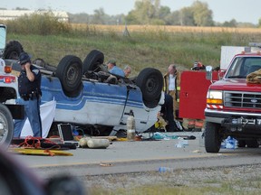 Emergency crews respond to  a van crash on Interstate 69 in Gibson County in Southwestern Indiana, Thursday, Sept. 24, 2015. Sgt. Bruce Vanoven of the Gibson County Sheriff's Office says the 16-passenger van was carrying 24 people when a tire blew out Thursday afternoon, causing the vehicle to overturn. (Jason Clark/Evansville Courier & Press via AP)