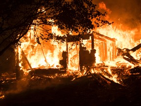 Firefighters hose down a house in the 3000 block of Clogg's Road in Kingston Thursday, Sept. 24. Kingston Fire and Rescue responded to the call just after 10 p.m. Firefighters remained on scene Friday morning.
James Paddle-Grant/For The Whig-Standard