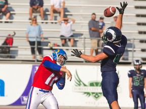 Oaks quarterback Adam Worby manages to get a pass over Laurier linebacker Ben Padega during their United Way football game in London, Ont. on Thursday September 24, 2015. 
Oakridge dominated early and won 28-22 over a game Laurier squad.
Mike Hensen/The London Free Press/Postmedia Network