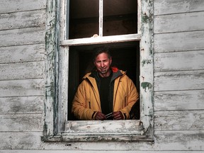 Sarnia musician Mike Stevens looks out the window of an old Hudson Bay outpost at Fort Ross, Nunavut during a shore visit while he was part of a recent voyage across the Northwest Passage. (Handout/Sarnia Observer/Postmedia Network)