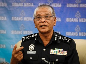 Malaysian police Deputy Inspector Gen. Noor Rashid Ibrahim gestures as he speaks during a press conference at the police headquarters in Kuala Lumpur, Malaysia Wednesday, Sept. 23, 2015. He says eight people, including four believed to be ethnic Uighurs, have been detained in connection with last month's bombing of a shrine in Bangkok that killed 20 people. (AP Photo/Joshua Paul)