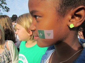 Maliyah Ogorek, 8, joins her classmates at St.-Thomas-d'Aguin Catholic Elementary School on Friday September 25, 2015 in Sarnia, Ont., for a ceremony as part of Franco-Ontarian Flag Day. (Paul Morden/Sarnia Observer/Postmedia Network)