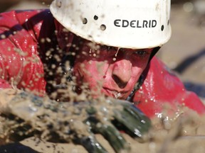 A Royal Military College of Canada cadet emerges from a water-filled trench during the annual First Year Orientation Program obstacle course in Kingston, Ont. on Friday, Sept. 25, 2015.Elliot Ferguson/Kingston Whig-Standard/Postmedia Network