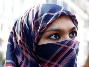 Zunera Ishaq talks to reporters outside the Federal Court of Appeal after her case was heard on whether she can wear a niqab while taking her citizenship oath, in Ottawa on Tuesday, September 15, 2015. The federal government says it plans to challenge the decision that quashed its attempts to ban face coverings at citizenship ceremonies. THE CANADIAN PRESS/ Patrick Doyle