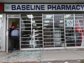 Ottawa Police were at the scene of a robbery at 2571 Baseline Road in Ottawa Ontario Friday Sept 25, 2015. A man was seen leaving Baseline Pharmacy with a garbage bag full of drugs Friday afternoon. 
Tony Caldwell/Ottawa Sun
