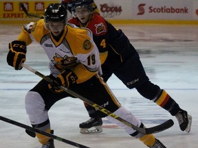 Sarnia Sting rookie Ryan McGregor tries to toe drag Erie Otters defenceman Jordan Sambrook with Otter Taylor Eagan pursuing the play. McGregor made his Ontario Hockey League debut as the Sting hosted Erie in their season opener Friday night at the Sarnia Sports and Entertainment Centre. (Terry Bridge, The Observer)