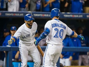 Toronto Blue Jays outfielder Jose Bautista celebrates a home run with Josh Donaldson during MLB play against the Tampa Bay Rays at the Rogers Centre in Toronto on Friday September 25, 2015. (Ernest Doroszuk/Toronto Sun/Postmedia Network)