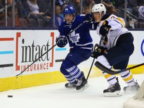 Maple Leafs forward Mitch Marner (left) steals the puck from Buffalo Sabres’ Mark Pysyk during pre-season action on Friday night at the Air Canada Centre. Marner, the fourth overall pick this summer, will head back to the OHL’s London Knights. (DAVE ABEL/TORONTO SUN)