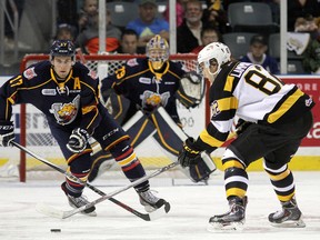 Kingston Frontenacs' Juho Lammikko tries to get a shot off against Barrie Colts' Justin Scott and goalie Mackenzie Blackwood during the opening game of the Ontario Hockey League season at the Rogers K-Rock Centre in Kingston on Friday. (Ian MacAlpine /The Whig-Standard)