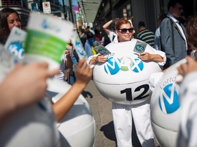 Janine Lubey, centre, promotes the Lotto-Max lottery at Yonge and Dundas Square in Toronto on Sept. 25, 2015. (THE CANADIAN PRESS/Marta Iwanek)