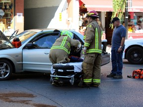 Kingston Police, Frontenac Paramedic Services, and Kingston Fire and Rescue responded to a motor-vehicle collision on Brock Street between Wellington and King streets  in Kingston, Ont. on Saturday September 26, 2015 just before 3 p.m. The female driver of the beige Mazda was taken to hospital as a precaution. Steph Crosier/Kingston Whig-Standard/Postmedia Network