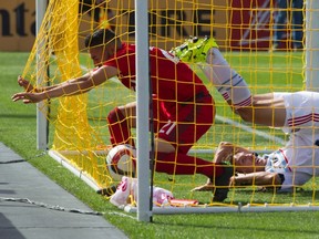 TFC's Jonathan Osorio gets tangled in the net after scoring against Chicago on Saturday. (CANADIAN PRESS)