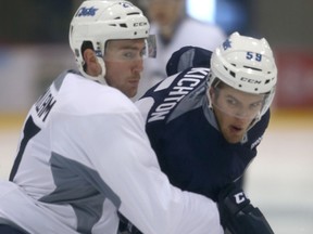 Winnipeg Jets Andrew MacWilliam (left) and Brendan Kichton battle on the ice during training camp on Saturday, September 19, 2015. (Winnipeg Sun/Postmedia Network)