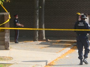 Three men were wounded by gunfire at a Toronto Community Housing complex on Scarlettwood Ct. early Saturday. Toronto Police Forensics officers spent all morning gathering evidence at the triple shooting scene. (Chris Doucette/Toronto Sun)