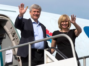 Conservative Leader Stephen Harper and wife, Laureen, wave as they step off the campaign plane on Friday, September 25, 2015, in Riviere du Loup, Quebec. THE CANADIAN PRESS/Ryan Remiorz