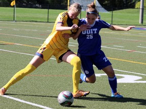 Queen's Gaels's Tara Bartram battles for the ball against the UOIT Ridgeback's Katherine Koehler-Grassau. The Gaels fell to the Ridgebacks 1-0 in Kingston, Ont. on Saturday September 26, 2015. Steph Crosier/Kingston Whig-Standard/Postmedia Network