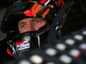 Carl Edwards, driver of the #19 Sport Clips Toyota, sits in his car during practice for the NASCAR Sprint Cup Series Sylvania 300 at New Hampshire Motor Speedway on September 26, 2015 in Loudon, New Hampshire. (Chris Trotman/AFP)