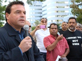 Councillor Giorgio Mammoliti speaks to taxi drivers at a rally opposing the ride-sharing service Uber in Scarborough on Sept. 26, 2015. (SHAWN JEFFORDS/Toronto Sun)