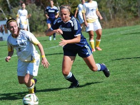 Lady Vees' Brianne Rodrigue is chased by a Nipissing Lakers player during OUA women's soccer action at the LU soccer fields on Saturday. The Vees won 5-2. Keith Dempsey/For The Sudbury Star