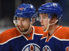 Edmonton Oilers' Anton Slepyshev, left and Connor McDavid speak during a break against the Minnesota Wild's during the first period of an NHL pre-season hockey game in Saskatoon, Sask., on Saturday, September 26, 2015. THE CANADIAN PRESS/Liam Richards