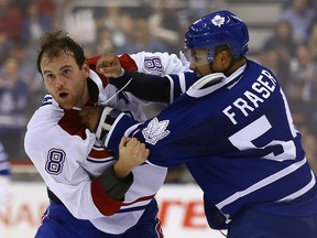 Maple Leafs tough guy Mark Fraser fights with the Canadians Zack Kassian during pre-season action at the Air Canada Centre last night. (Dave Abel/Toronto Sun)