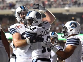 Toronto Argonauts' Kevin Elliott celebrates with teammates after scoring a touchdown against the Ottawa Redblacks during first half CFL action in Ottawa on Saturday, Sept. 26, 2015. (THE CANADIAN PRESS/Justin Tang)
