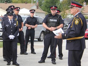 Sarnia Police Chaplain Rev. Roger Ellis, right, speaks to officers before Sunday's memorial service. Ellis is also the pastor at Redeemer Lutheran Church, where the service was held. Neil Bowen/Sarnia Observer/ Postmedia Network