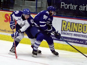 Sudbury Wolves forward David Levin battles Mississauga Steelheads forward Luke Kutkevicius during OHL action at Sudbury Community Arena. Ben Leeson/The Sudbury Star/Postmedia Network