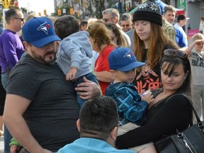 Lindsay and Ryan Pierce and their two sons register for the human circuit record attempt in downtown London on the weekend. (JOHN MINER, The London Free Press)