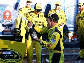 Matt Kenseth, driver of the #20 Dollar General Toyota, celebrates in Victory Lane after winning the NASCAR Sprint Cup Series SYLVANIA 300 at New Hampshire Motor Speedway on September 27, 2015 in Loudon, New Hampshire.   Sean Gardner/Getty Images/AFP
