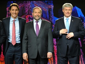 Liberal leader Justin Trudeau (L), NDP leader Thomas Mulcair (C) and Progressive Conservative leader Stephen Harper pose for a photo opportunity prior to the beginning of  the Globe and Mail Leaders Debate in Calgary, Alberta in this September 17, 2015, file photo. With Canada's three mainpolitical parties all getting around 30 percent support inpolls, the odds of a period of political instability after theOctober 19 election are rising. REUTERS/Mike Sturk/Files