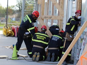 Kingston Fire and Rescue's Tactical Rescue crews take part in a week-long course to better their skills at the KFR training centre in Kingston, Ont. on Friday September 25, 2015. Steph Crosier/Kingston Whig-Standard/Postmedia Network