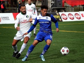 Edmonton FC Eddies' Dustin Corea gets past New York Cosmos' Danny Szetela at Clarke Park on September 27, 2015 in Edmonton, Alta.  Perry Mah/Edmonton Sun/Postmedia