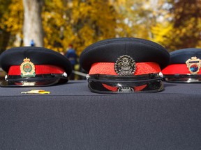 Hats of the fallen are seen during Police and Peace Officers' Memorial Day at the Alberta Legislature in Edmonton, Alta., on Sunday September 27, 2015. Alberta honoured 100 men and women who died in the line of duty at the ceremony. Ian Kucerak/Edmonton Sun/Postmedia Network