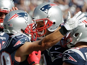New England Patriots quarterback Tom Brady celebrates his touchdown pass to wide receiver Danny Amendola, left, the 400th touchdown pass of Brady's NFL career, in the first half of an NFL football game against the Jacksonville Jaguars, Sunday, Sept. 27, 2015, in Foxborough, Mass. (AP Photo/Steven Senne)