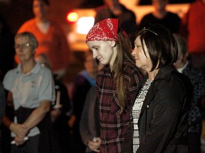 Valerie Warmerdam, with the red bandana, stands beside Bonnechere Valley Mayor Jennifer Murphy during the Eganville vigil held Sunday, Sept. 27, 2015, remembering the three women slain Tuesday. Valerie is the daughter of one of the victims, Nathalie Warmerdam.
MATT DAY/Ottawa Sun