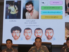 Thai National Police Chief Somyot Poomphanmuang, center, Deputy Police Chief Jakthip Chaijinda, left, and Police spokesman Prawut Thavornsiri sit in front of a chart of suspect bombers during a press conference in Bangkok, Thailand, Monday, Sept. 28, 2015.  (AP Photo/Sakchai Lalit)