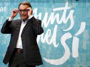 Catalan President Artur Mas reacts during a joint news conference with Oriol Junqueras, leader of Esquerra Republicana de Catalunya (ERC), and Raul Romeva, a former university professor and member of the European Parliament (unseen) in Barcelona, Spain, September 28, 2015. Separatists on Sunday won a clear majority of seats in Catalonia's parliament in an election that sets the region on a collision course with Spain's central government over independence. Spain's constitution does not allow any region to break away, so the prospect remains highly hypothetical.  REUTERS/Andrea Comas