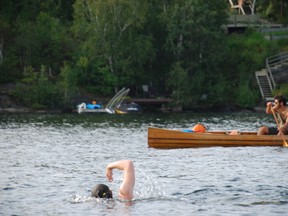 Swimmers get a canoe escort on a Lake Nepahwin crossing in this file photo. (Laura Young/For The Sudbury Star)