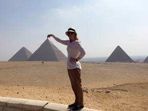 In this Aug. 30, 2015 photo, Courtney Bonnell poses with the pyramids in the background, in Giza, Egypt. (Courtney Bonnell/AP)