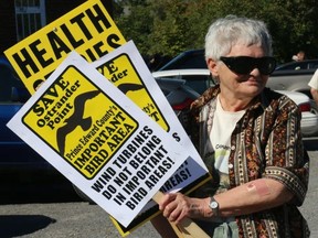 BRUCE BELL/THE INTELLIGENCER
Prince Edward County Field Naturalists president Myrna Woods was well armed for the anti-wind development rally held by the Alliance to Protect Prince Edward County at the Milford Fairgrounds on Sunday.