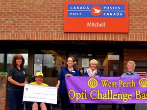 Members of the Mitchell Optimist Club and members of Opti Challenge Baseball were presented with a grant of $3,500 from the Canada Post Community Foundation recently. From left, Mitchell Optimist Club President Kathy Vivian, challenge baseball participant Jordan Sykes, Chairperson of Opti Challenge Baseball Dianne Oliver, Optimist Club President-elect Dianne Josling, postal assistant Colleen Appleby and Mitchell postmaster Nadine Storey. GALEN SIMMONS/MITCHELL ADVOCATE