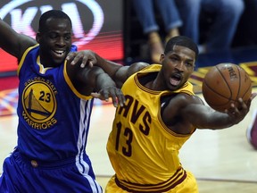 Cleveland Cavaliers Tristan Thompson drives against the Golden State Warriors Draymond Green during Game 3 of the 2015 NBA Finals on June 9, 2015 at the at Quicken Loans Arena in Cleveland, Ohio. AFP PHOTO  / TIMOTHY A. CLARY