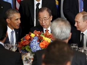 Russian President Vladimir Putin and U.S. President Barack Obama speak during the luncheon at the United Nations General Assembly in New York September 28, 2015. Between them is UN Secretary General Ban Ki-moon. REUTERS/Kevin Lamarque
