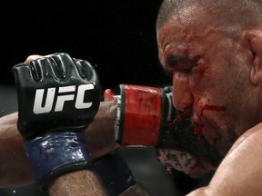 Leandro Issa takes a punch from Iuri Alcantara during their UFC match in Rio de Janeiro, Brazil August 1, 2015. (REUTERS/Ricardo Moraes)